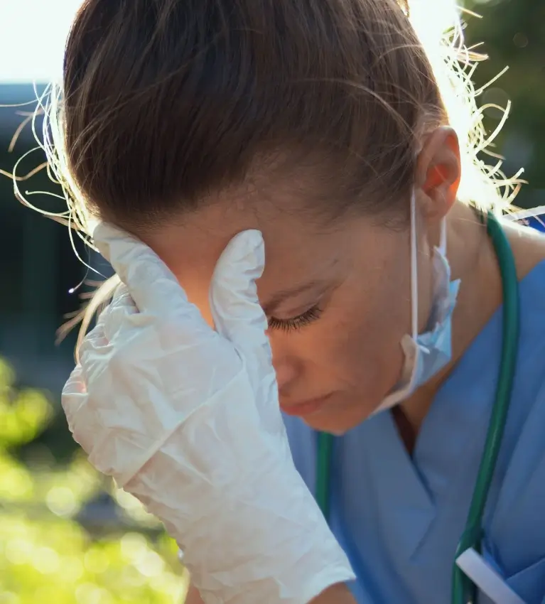 a doctor with her head in her hands