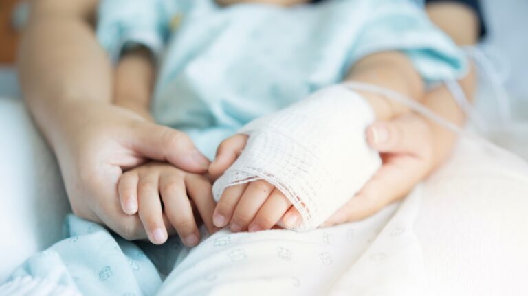 Child and parent in hospital bed