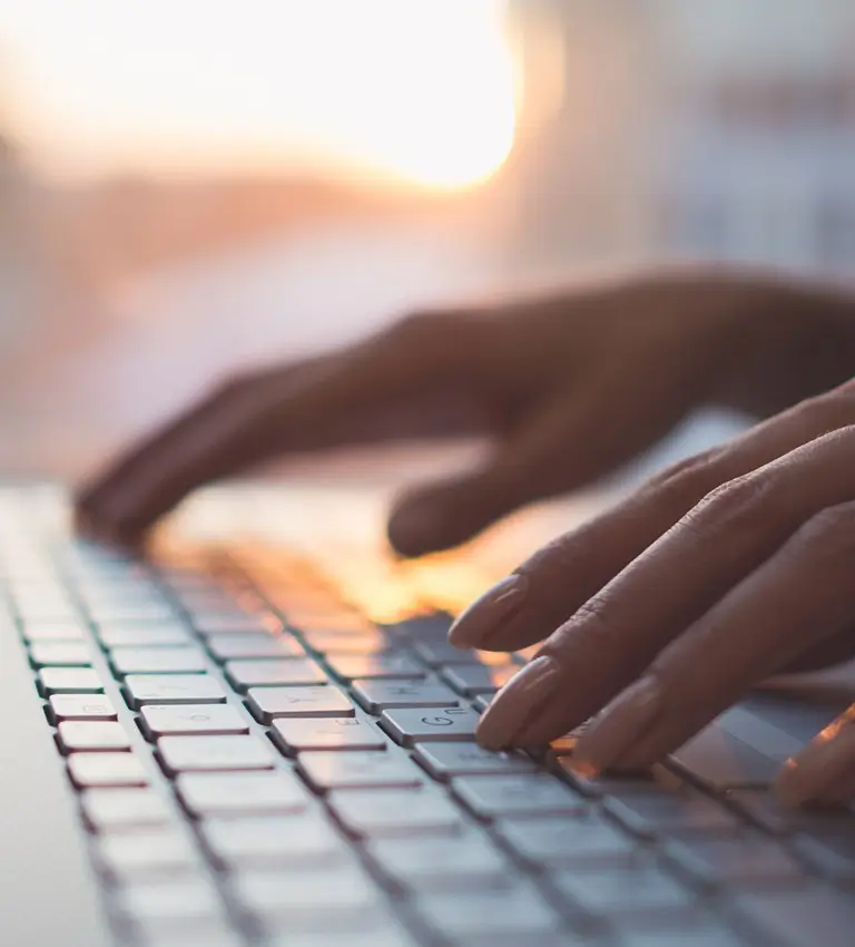 a person typing on a laptop