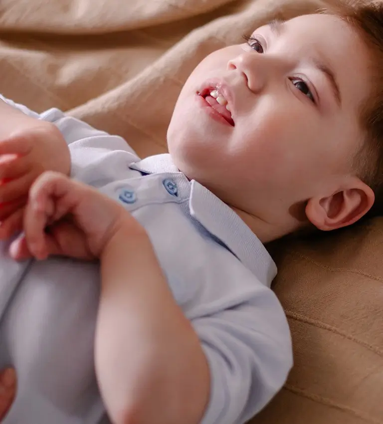 a baby laying on a bed