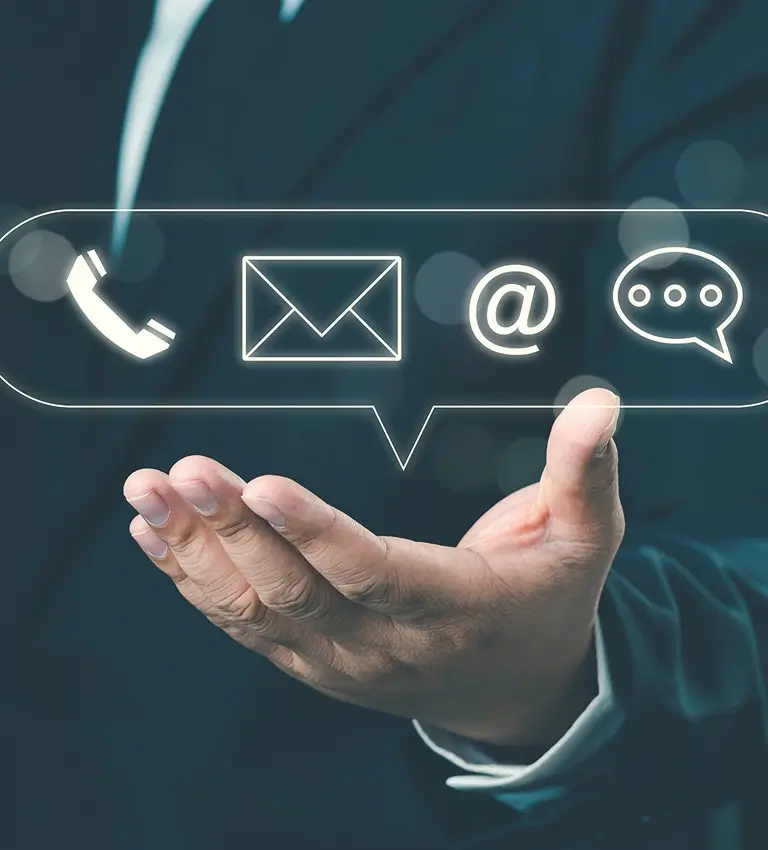 a businessman holding a phone and email icons