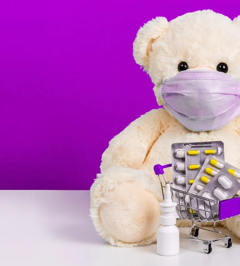 a teddy bear wearing a medical mask