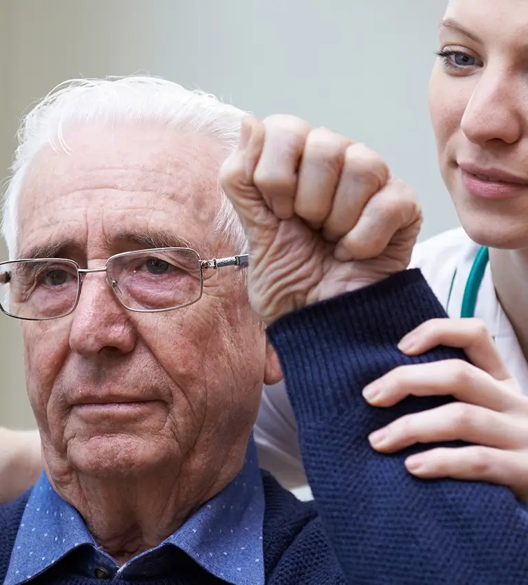 an elderly man being helped by a nurse
