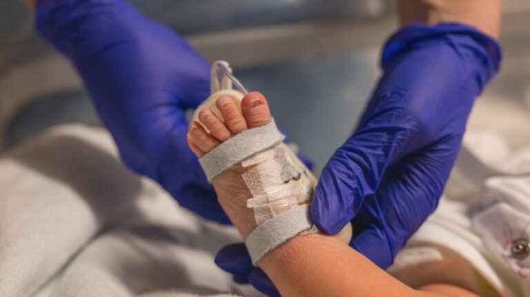 Doctor checking newborn baby