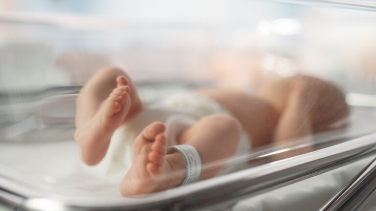 Newborn Baby lying in bassinet in a maternity hospital