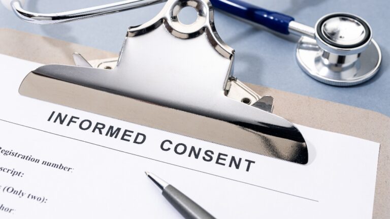 Informed Consent form and stethoscope on desk