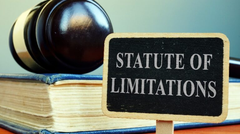 Statute of limitations sign, book and judge's gavel